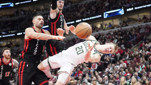 Chicago Bulls center Nikola Vucevic (9) flagrantly fouls Milwaukee Bucks guard AJ Green (20) 